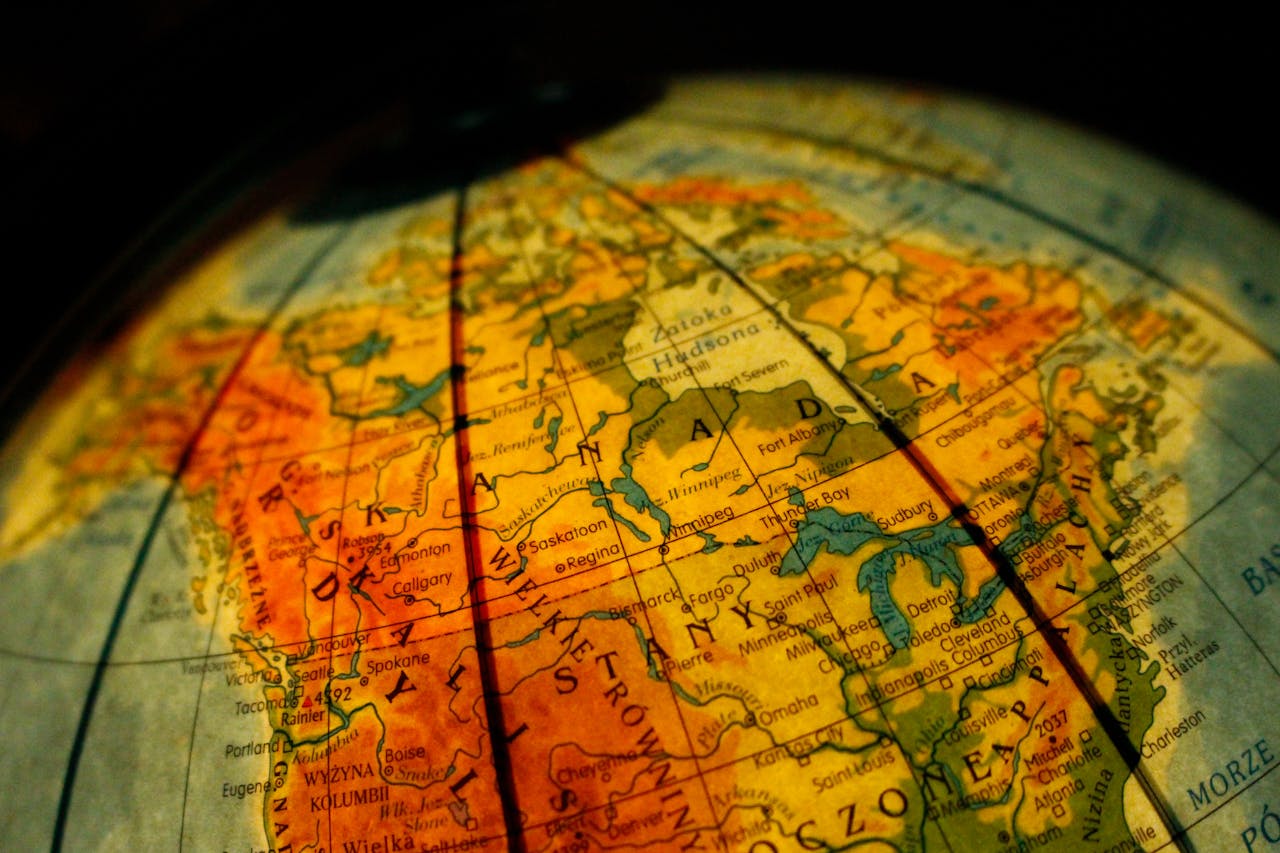 Close-up of a vintage globe focusing on Canada and the USA with a warm tone.